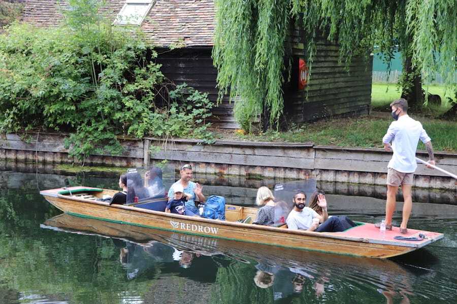 Chauffeured punt with clear screens separating passenger groups for a safer punt tour on the River Cam