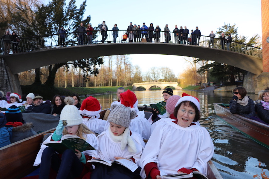 Carols on a Punt on the River Cam in Cambirdge with Garratt Hostel Bridge in the background.