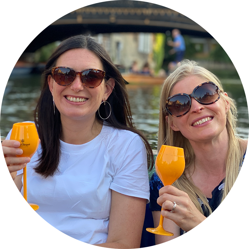 Ladies smiling and drinking whilst punting in Cambridge