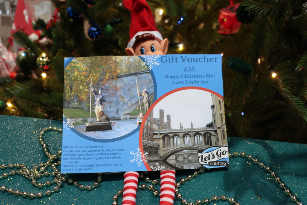 Christmas voucher for punting in Cambridge held by an elf