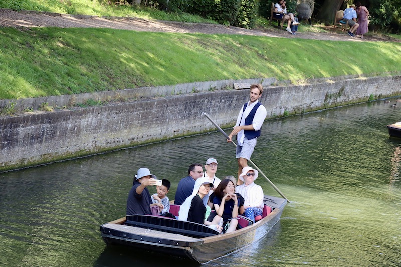 a punter making the tour fun, viewed during a cambridge punting tour