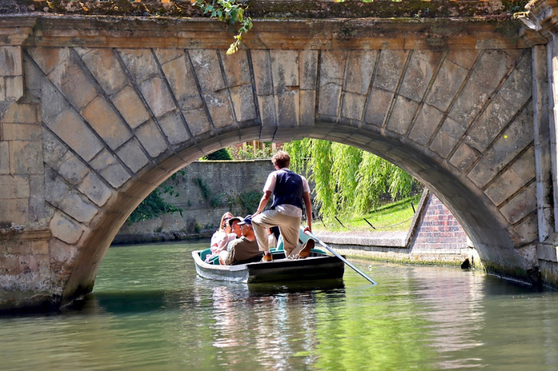 Punting boat in Cambridge on the River Cam gliding under Clare Bridge