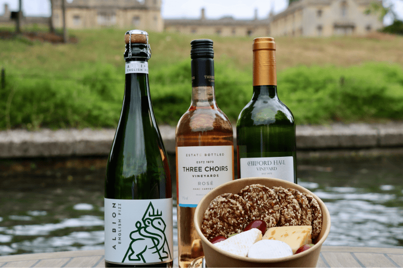 Albion and Three Choirs English wines beside a cheese box on the riverbank in Cambridge