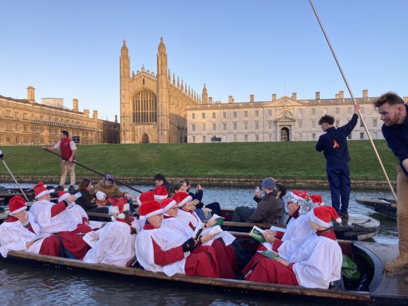 Christmas carols on the river with Let's Go Punting, with King's College Chapel behind.