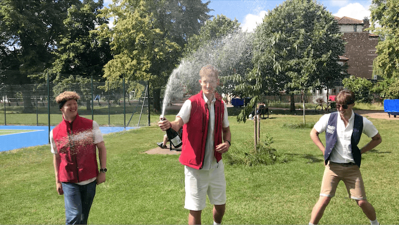 Chauffeurs Luke, Cam and Ben spraying prosecco to celebrate winning the punting relay race.